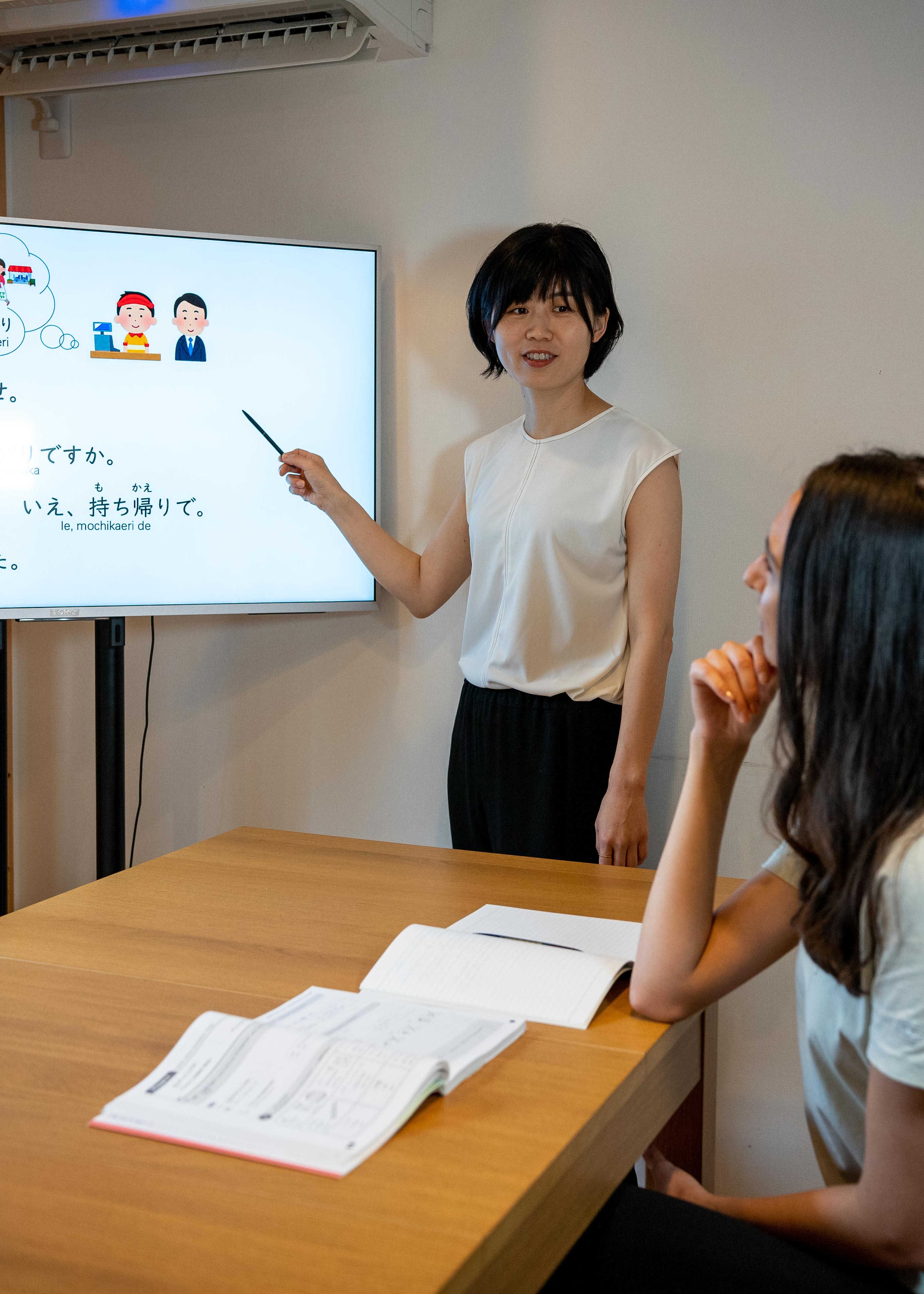 Students are watching the whiteboard to learn Japanese lessons